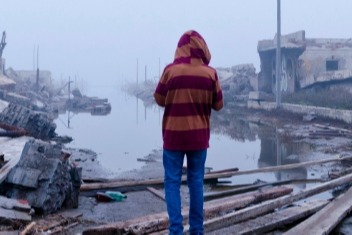 Person looking at flood damage